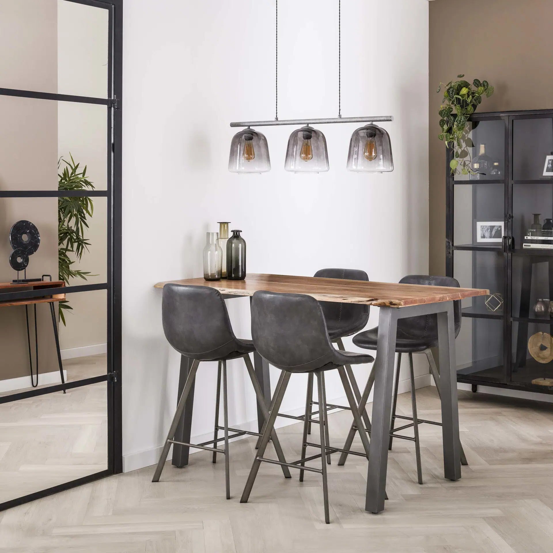 Modern dining area with a wooden table and gray chairs in a well-lit room.
